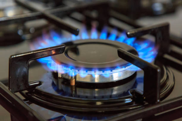 Close up photo of a gas burner with blue flame